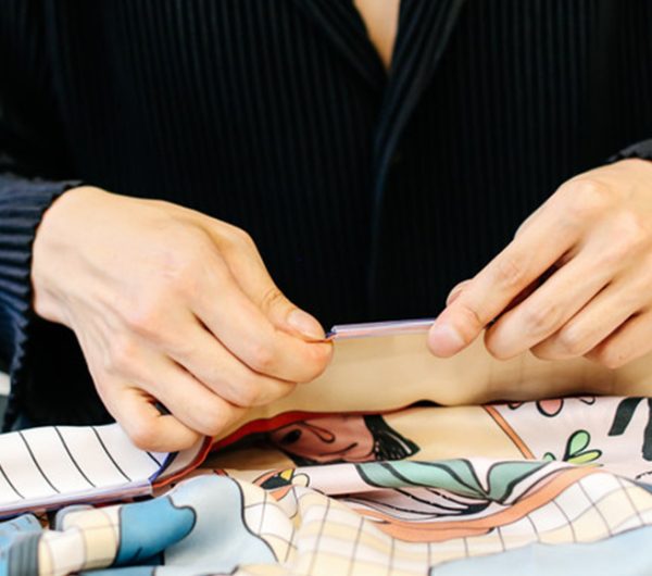 A female designer working with printed satin textile